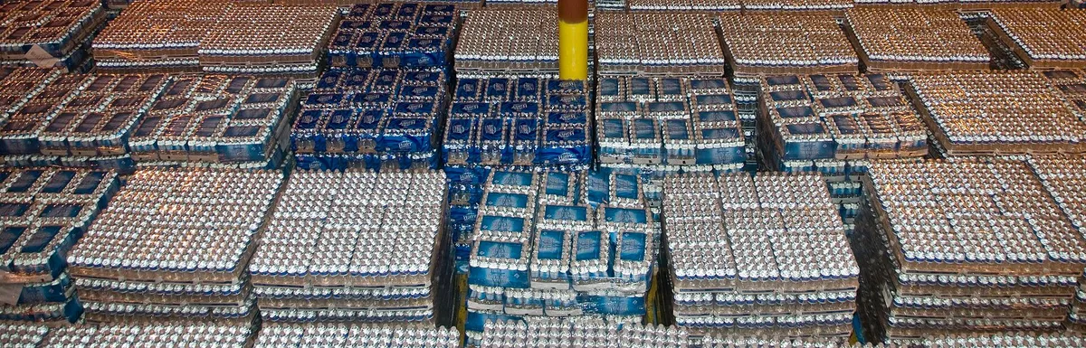 Warehouse seen from above, with rows of pallets of bottled water.